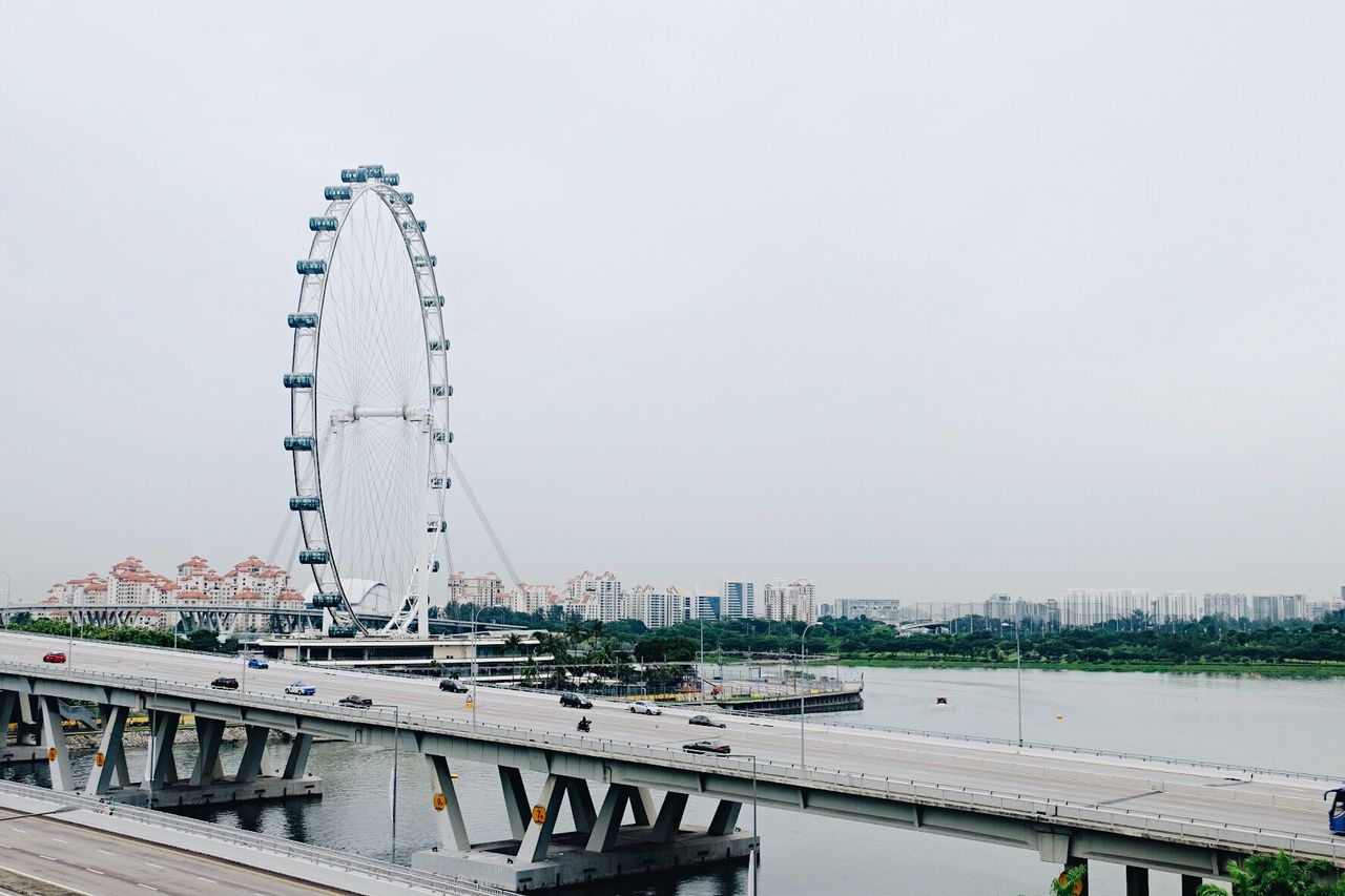 View of the Singapore Flyer, city skyline, and a busy bridge on a clear day.