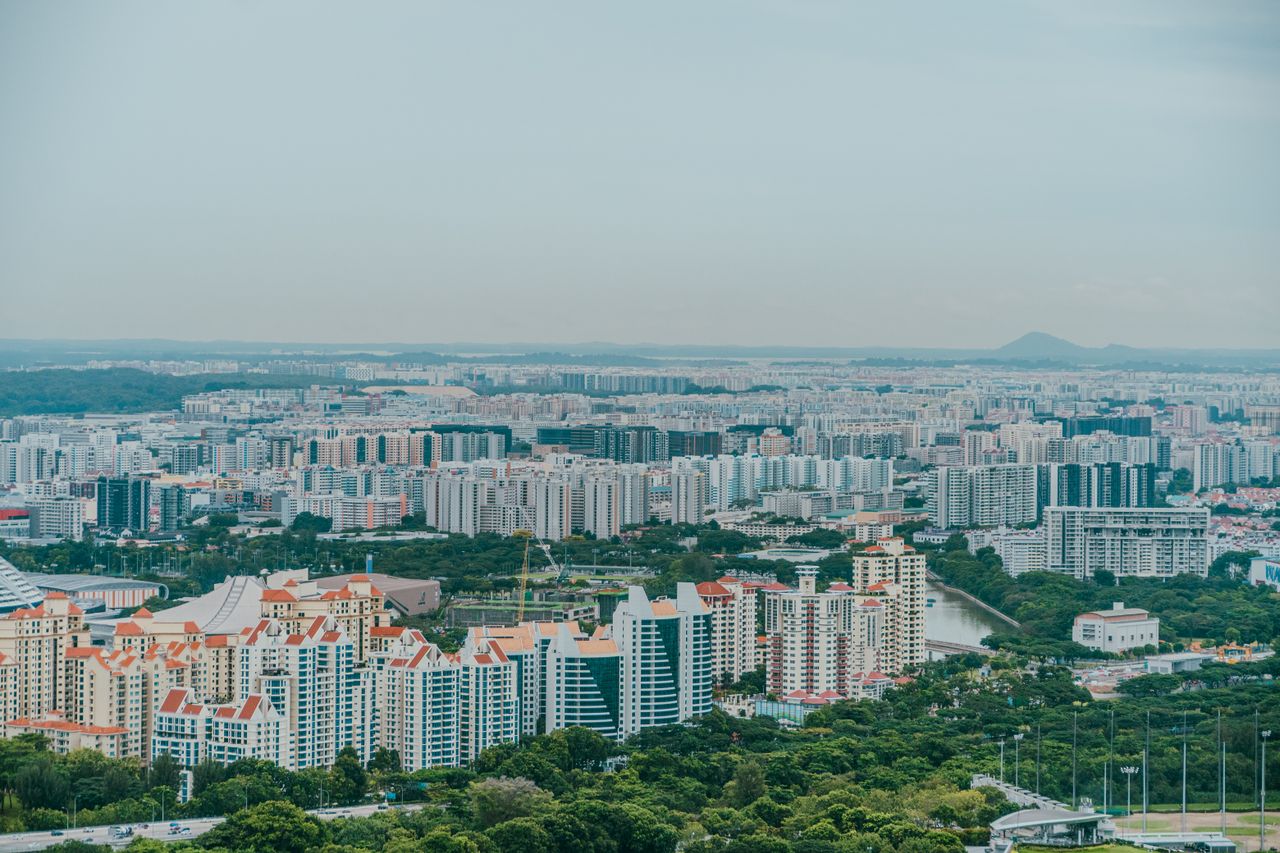 A panoramic aerial view showcasing the dense urban sprawl of Singapores skyline with modern architecture.